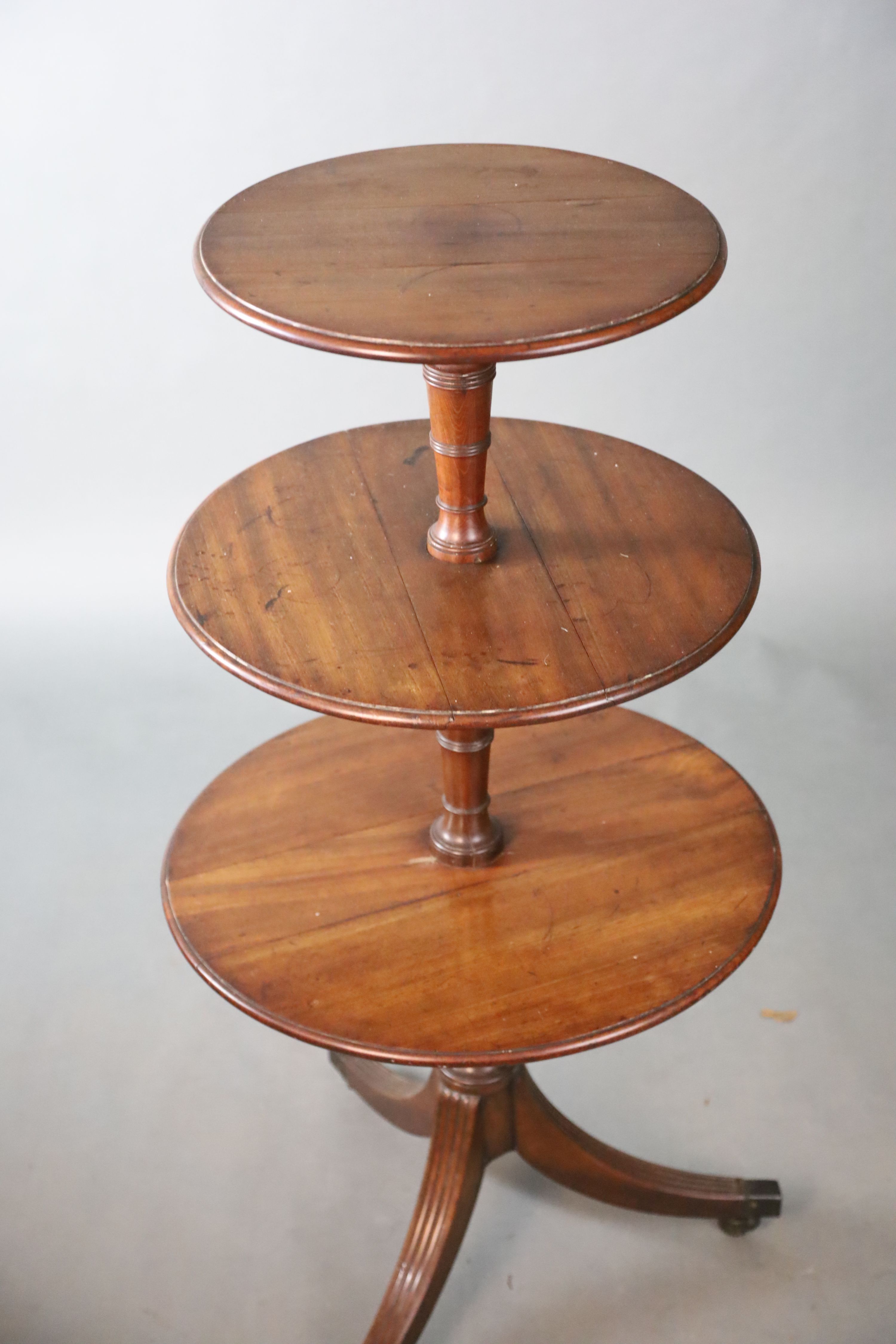 A Regency mahogany three tier dumb waiter, Diam. 58.5cm H.117cm